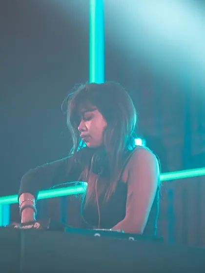Caught in a moment of concentration under the cool blue stage lights. My focus is always on delivering a seamless and powerful musical experience.