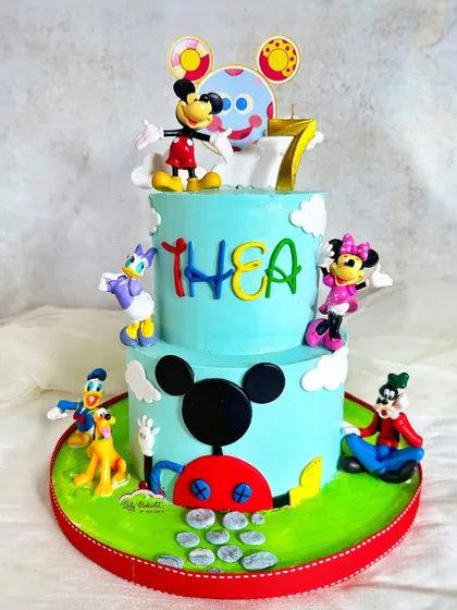 Oh, boy! A fun-filled Mickey Mouse Clubhouse cake, featuring Mickey, Minnie, Donald, Goofy, and Pluto. This two-tier cake brings the whole gang together for a birthday celebration.