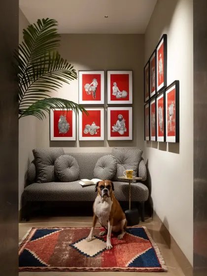 This cozy seating alcove in the SDA Project features a chic settee from our Koko by K2India collection. Paired with vibrant art and a geometric rug, it creates a personal retreat that is both elegant and comfortable, even for the family pet.