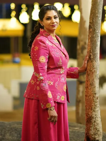 A side profile of the stunning pink embroidered jacket set, showing its elegant tailoring.