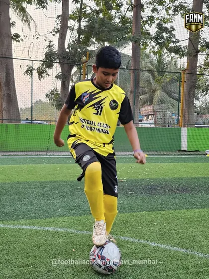 Confidence on the ball starts here. A player practices a foot-on-ball stance, a simple but crucial exercise for developing balance and control.