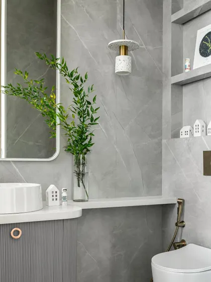 In the daughter’s bathroom, we brought her bathtub dream to life with a custom-made design. Pink fluted and grey marble tiles adorn the walls, while niches above the WC allow for decorative elements.