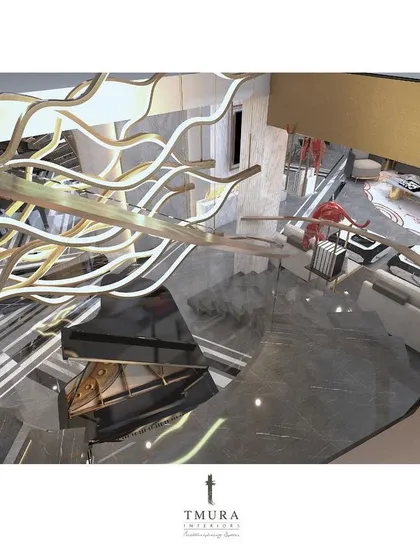 A top-down view of the magnificent, custom-lit staircase, showing how its organic, branch-like form becomes a central art piece connecting the floors of the home.