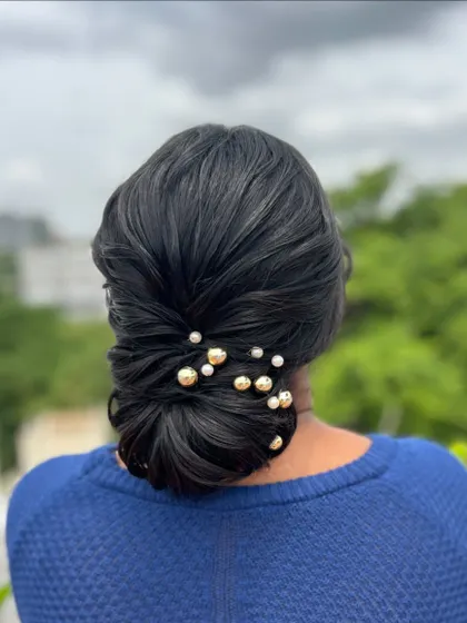 The final look of the pearl-adorned low bun, perfect for any elegant occasion.