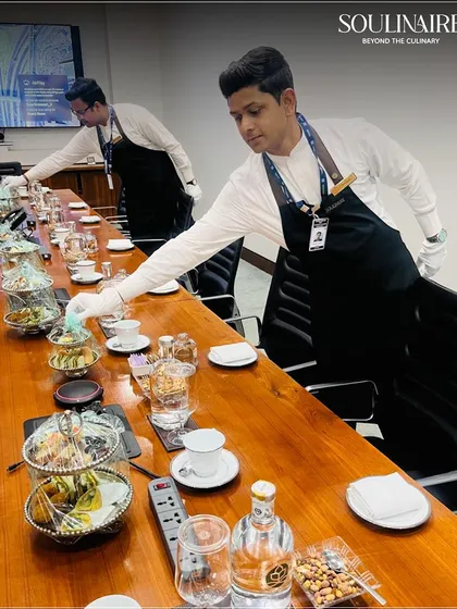 Our service team meticulously setting up for a corporate boardroom meeting. We bring the same level of precision and elegance to intimate corporate gatherings as we do to large-scale events.