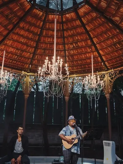 A live band performs under the chandeliers of the Colonial Bandstand during a Sangeet night.