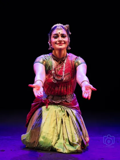 A welcoming gesture, inviting the audience to share in the experience of the dance.