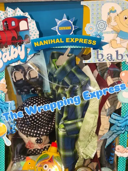 This 'Nanihal Express' hamper is packed in a single large tray, filled with clothes, shoes, and other baby items.