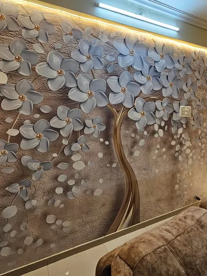 This living room features a 3D wallpaper of a flowering tree with grey blossoms and a golden trunk, creating a sophisticated and modern look.