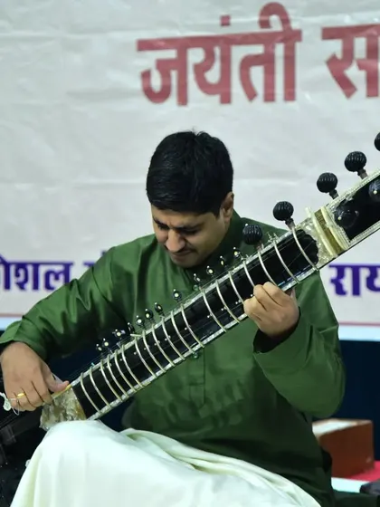 A close up shot showing the intricate handwork involved in playing the sitar.