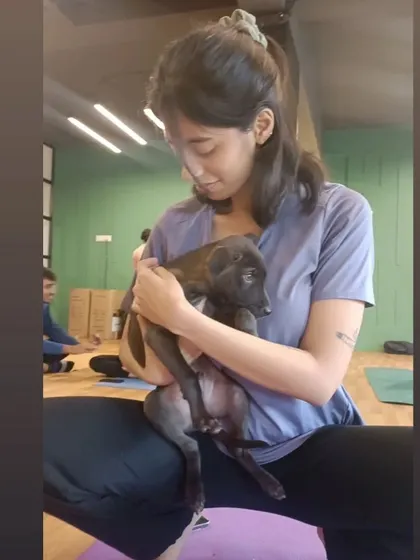 A tender moment between a student and a small black puppy. The love and empathy in the room during these sessions is palpable.