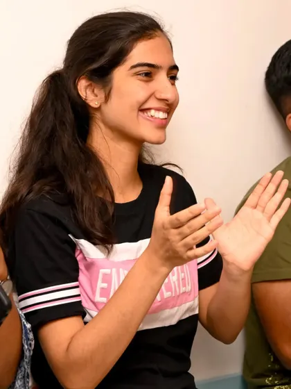 A smiling audience member clapping. Capturing the audience's appreciation is key to telling the full story of a successful event.