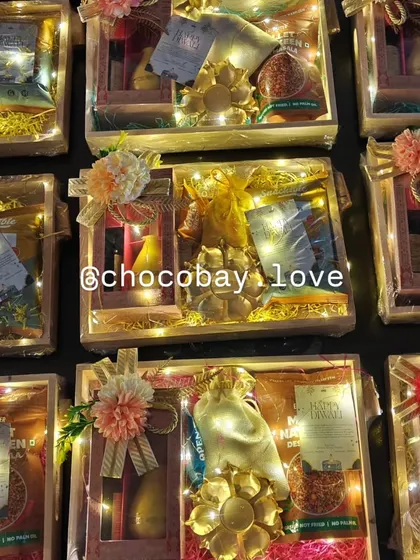 This image shows a batch of my wooden gift hampers illuminated with fairy lights. Each one is fully customizable with different treats and decor, making them suitable for any corporate occasion.