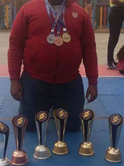 A player with his impressive collection of medals and trophies from the SFA Championship.