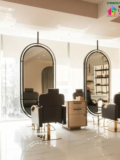The reflection in the large, suspended mirrors enhances the sense of space and light within the salon.