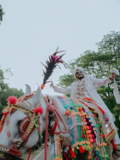 The grand entrance. A Baraat is more than a procession; it's a celebration of the journey to come. I focus on capturing the groom's joy and the vibrant energy of his family and friends in this unforgettable moment.