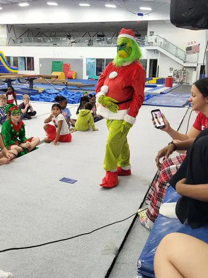The Grinch interacting with the kids during story and game time at our special holiday event. These character appearances make our parties truly memorable.