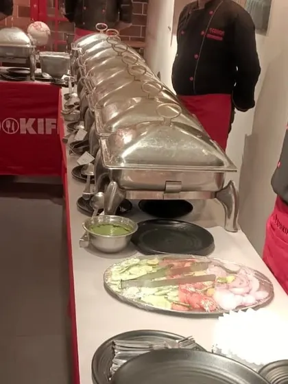 A view from behind the buffet line, showing our staff's readiness and the fresh salad platter prepared for a corporate event.