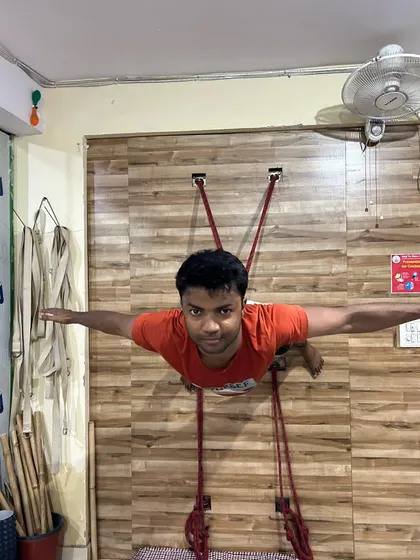 Another student performing the suspended Superman Pose. The focus and determination in his eyes reflect the inner strength being built alongside the physical power.