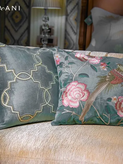 A perfect collection for adding a light and airy touch to your summer decor. These two teal cushions, one with a geometric pattern and the other with floral and bird embroidery, bring nature indoors.