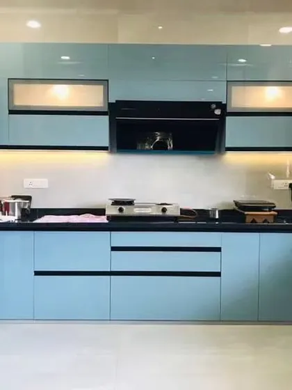 This L-shaped kitchen uses a cool powder blue for a sleek, modern look. The black hardware and countertop provide a sharp, defining contrast.