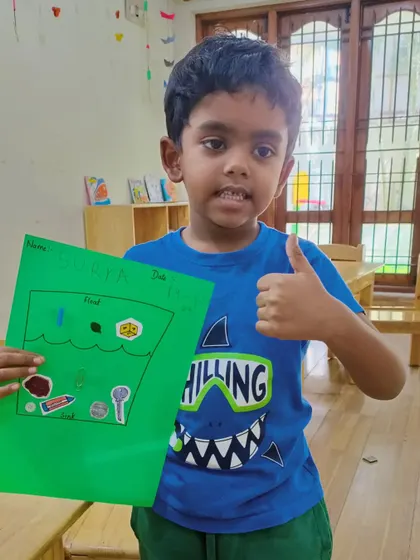 A big thumbs up for science! This camper is excited about his float and sink experiment results.