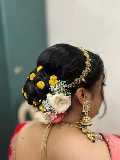 You can never go wrong with a floral bun. This classic hairstyle is perfect for weddings and traditional events, adding a touch of grace and elegance.