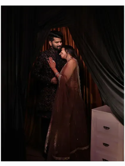A sweet, candid moment of the couple embracing and laughing during their reception.