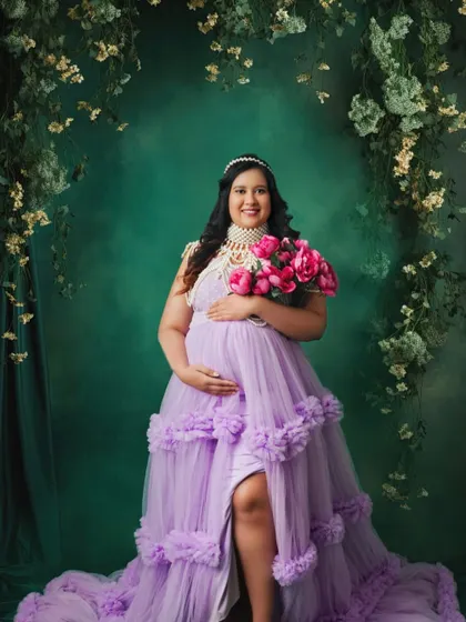 This mom-to-be looks absolutely radiant in a lavender gown, surrounded by a cascade of flowers. A portrait fit for royalty.