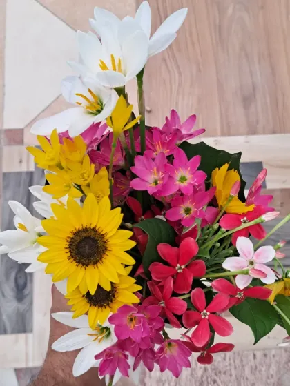 A bouquet of flowers picked directly from my terrace, featuring sunflowers, rain lilies, and more.
