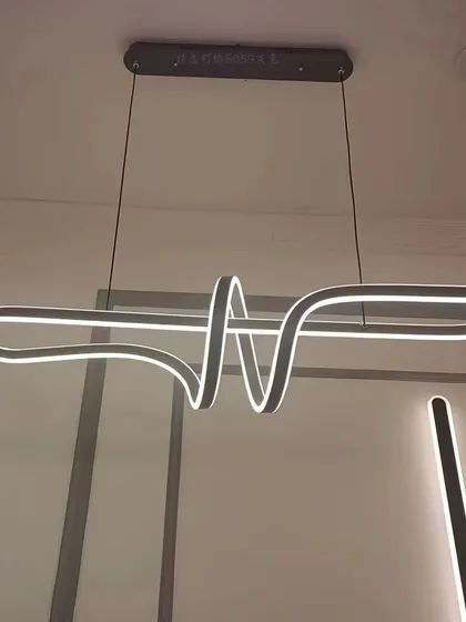 An abstract, ribbon-like linear pendant. This fixture is a true conversation starter, perfect for a modern and artistic home.