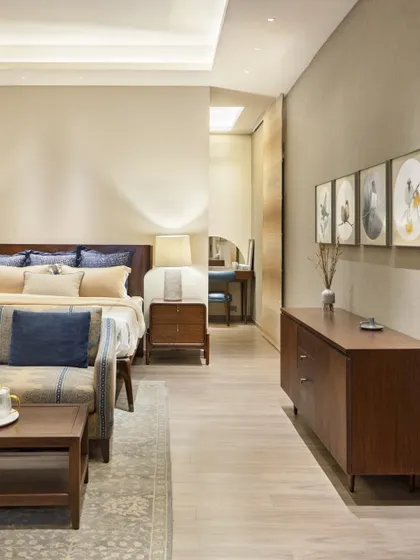 A wide shot of the master bedroom at Max128, showing the spacious layout and harmonious blend of colors and materials.