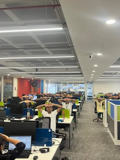 A full view of the office floor at MRI Software, with every employee engaged in a mindful stretching exercise.