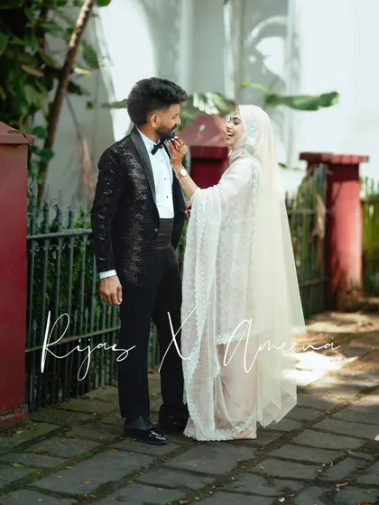 A playful moment where the bride adjusts the groom's beard, a small, intimate gesture full of affection.