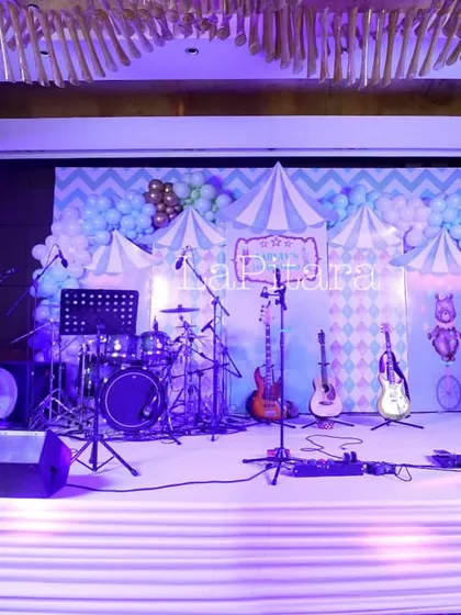 For another carnival-themed event, we set up a live band stage with a backdrop of pastel balloons and circus tent patterns. The lighting and sound equipment were integrated into the decor for a professional finish.
