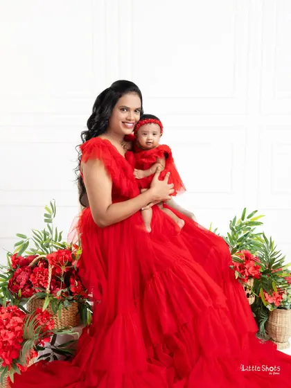 A mother's love, captured in a bold and beautiful way. Dressed in stunning matching red gowns, this mother and daughter duo create a powerful and loving portrait.
