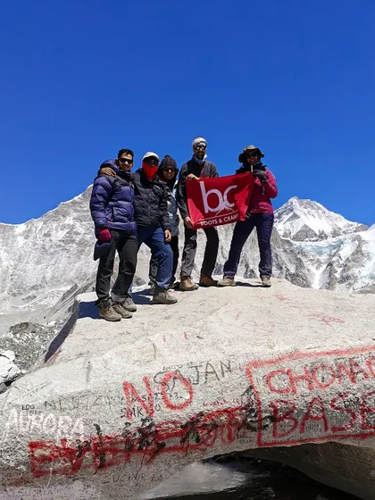 A small group of our trekkers posing with the B&C flag at the EBC rock. We foster a close-knit team environment on all our treks, ensuring everyone feels supported.