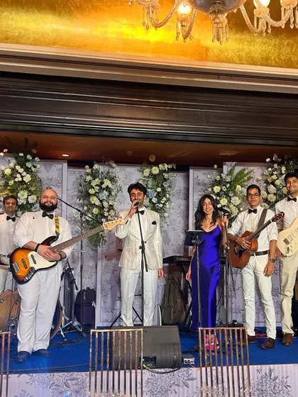 The full band on stage, dressed in coordinated outfits for a themed wedding event. We look as good as we sound.
