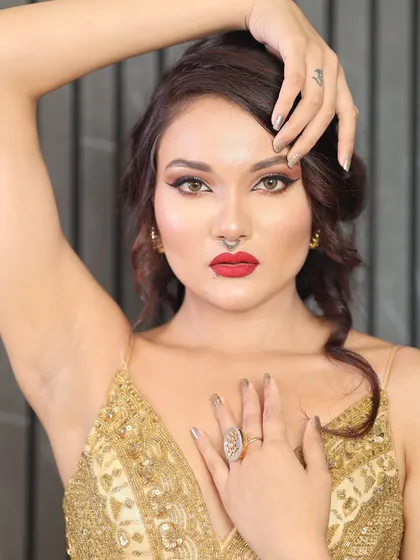 Here you can see how a simple yet striking metallic chrome manicure completes a glamorous evening look. The solid color on these elegant nails perfectly complements the gold dress and bold makeup, showing how your nails can be the ultimate accessory.