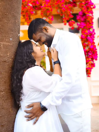An intimate embrace against a backdrop of bright pink bougainvillea flowers. Using natural elements adds so much beauty to pre-wedding photos.