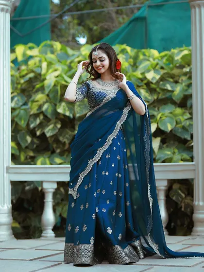 The silver embroidery on the blue fabric creates a celestial, starry-night effect.