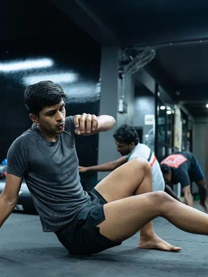 A student practices his ground movement, an essential drill for improving mobility in grappling.