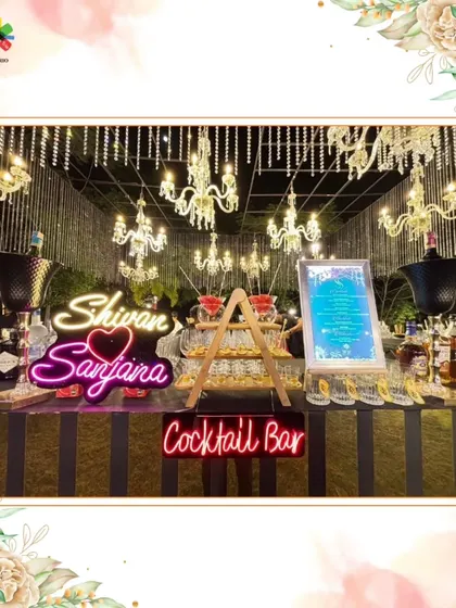 A stunning, personalized bar setup for Shivani & Sanjana's wedding. The neon sign and martini tower create a glamorous and celebratory focal point.