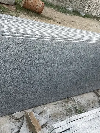 A stack of uniform grey granite slabs, showing the large quantity I can supply for big projects.