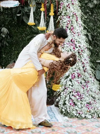 A playful dip during the Haldi ceremony. We encourage our couples to be spontaneous and have fun, resulting in photos that are full of life and energy.