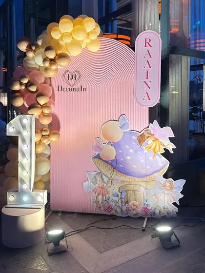 Another shot of the '1' marquee light and fairy house, showing the soft glow of the lights and the detailed illustration.