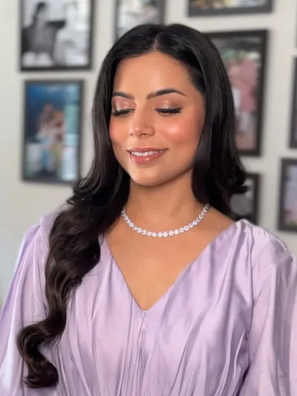Here is the look in indoor lighting. The makeup remains flawless, with a soft shimmer on the eyes and a glossy lip that completes the dewy look.