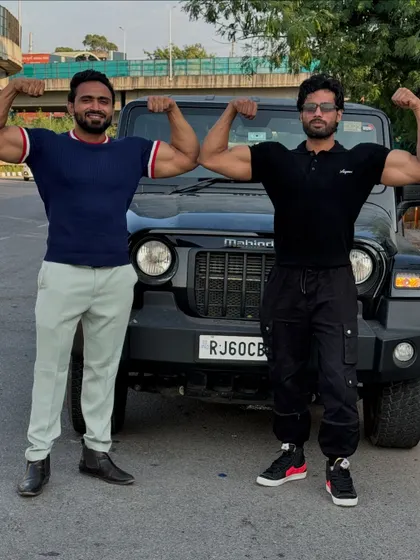 Double biceps pose with my friend in front of a Thar.