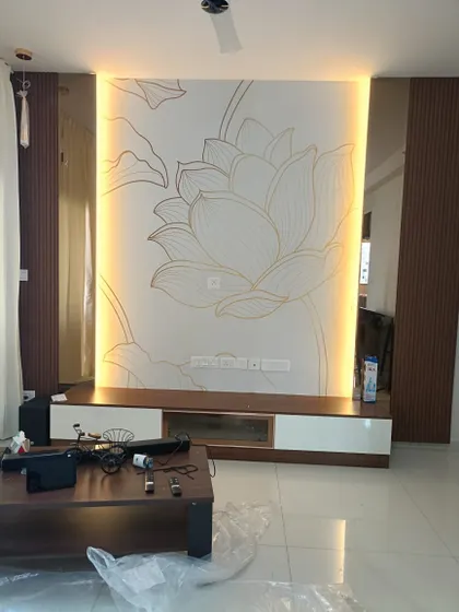 A minimalist lotus line art mural installed on a TV wall. The design is enhanced with custom backlighting, which I carefully work around to create a warm, ambient glow.