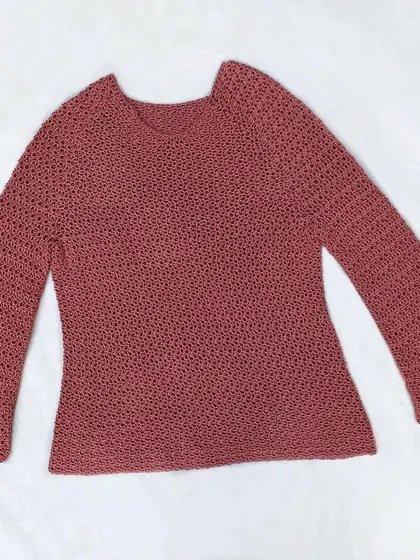 A full view of the finished Etoile Sweater, laid out to show its shape and the bell-sleeve design. Every crochet top is made to order, so we can adjust the length of the body and sleeves to your preference.